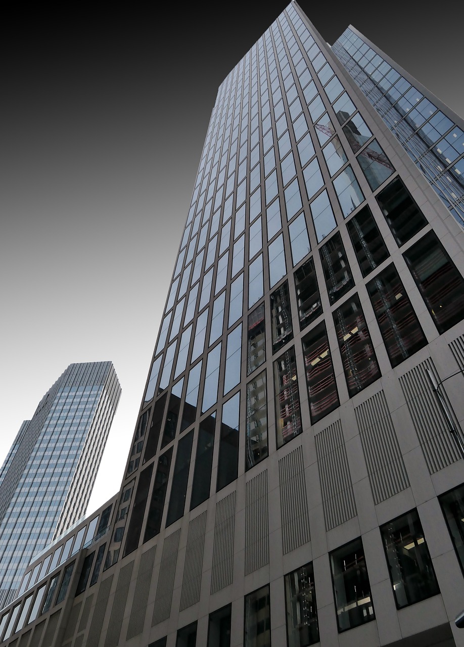 View of a tall modern office building from below.